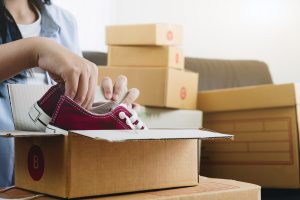 Man packing shoes in the boxes