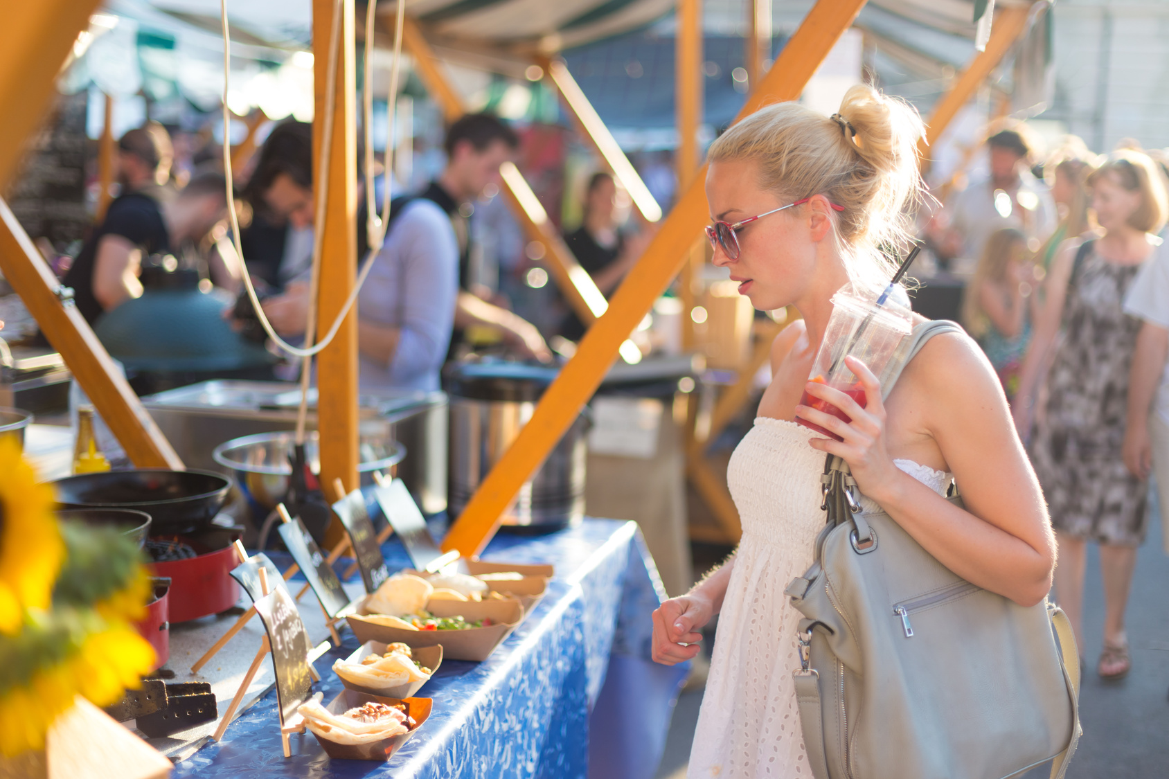 Woman buying meal at street food festival.
