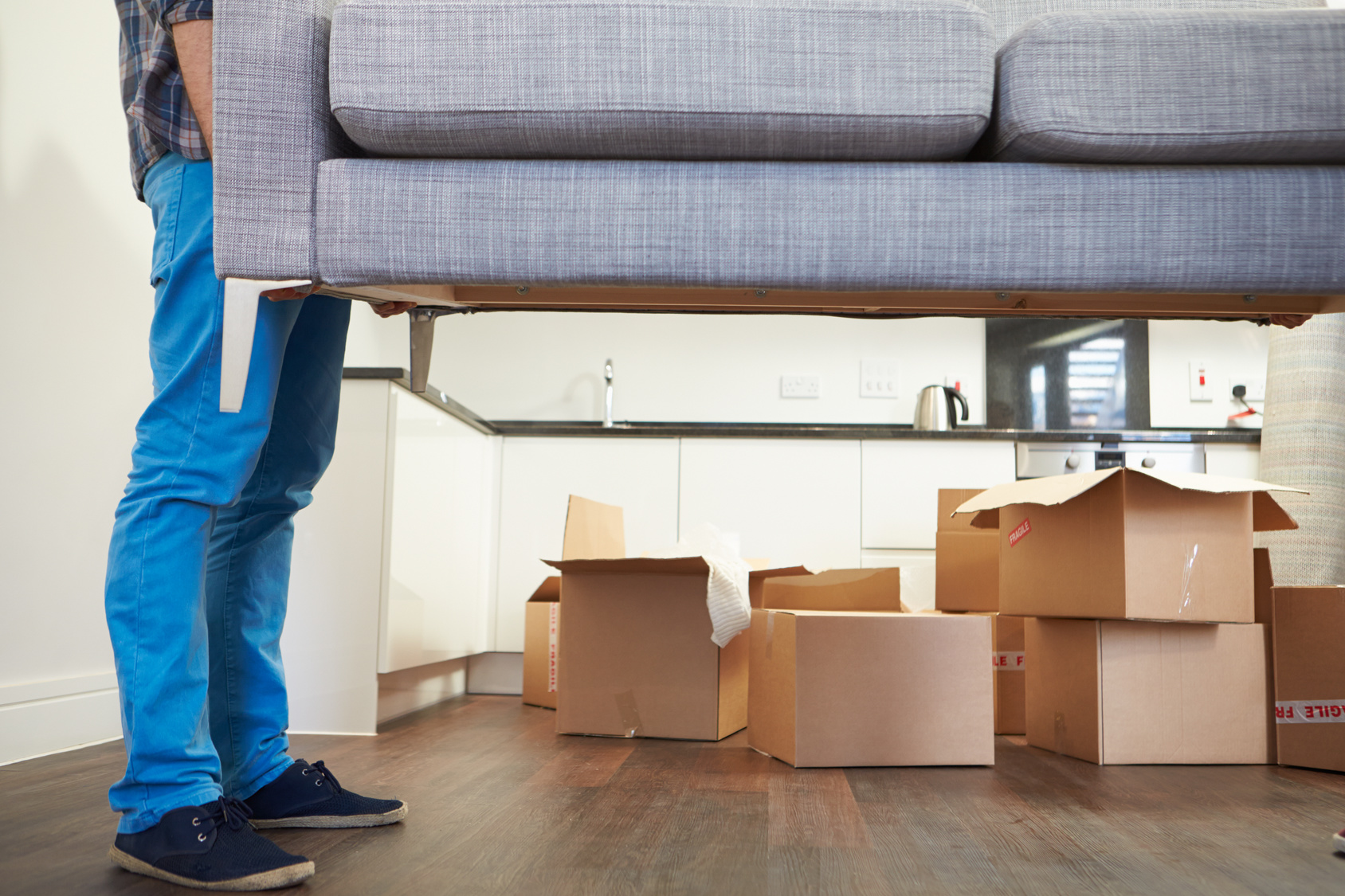 Man-Carrying-Sofa-When-Moving-into-New-House