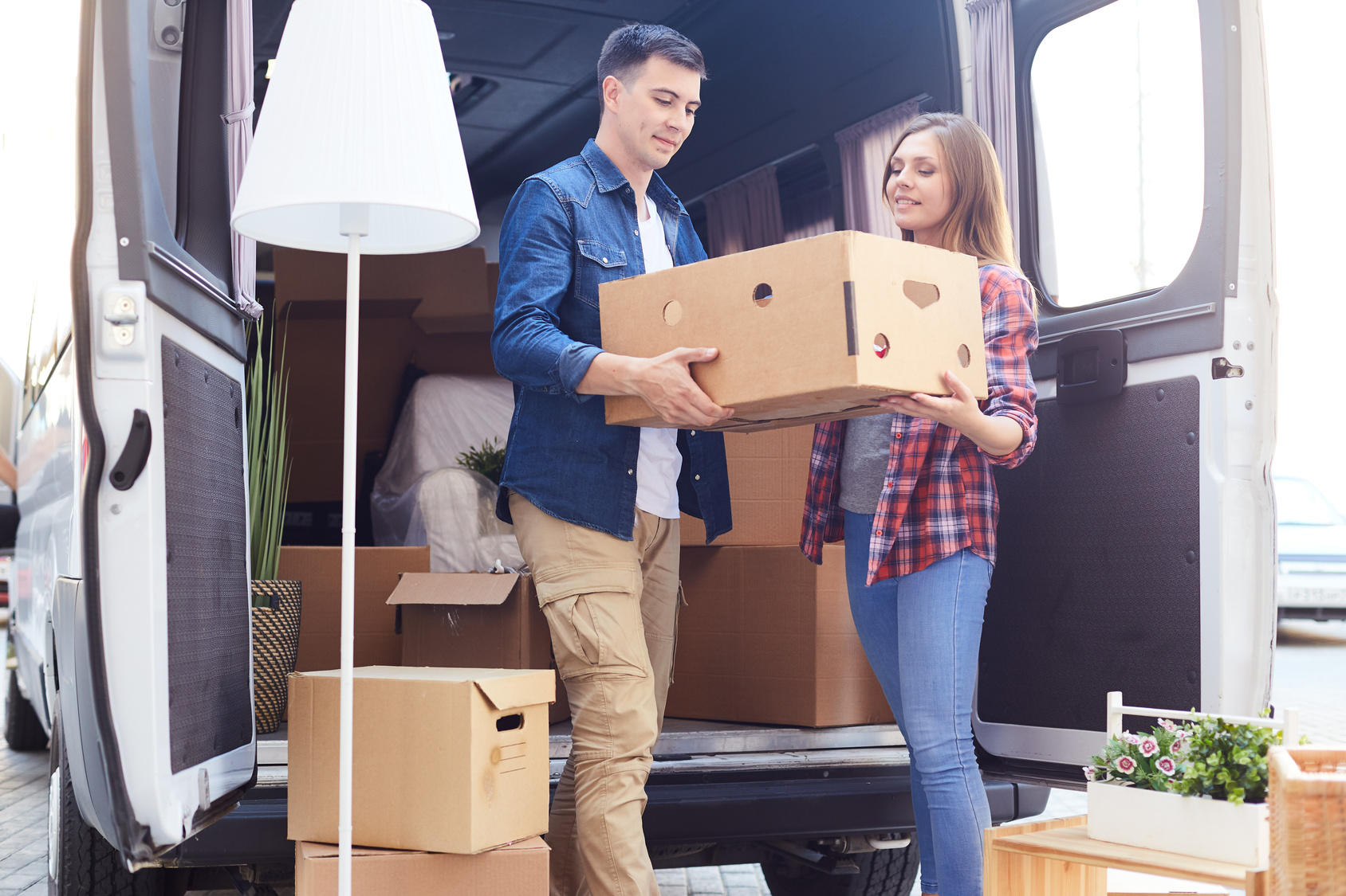 Young Couple Unloading Van